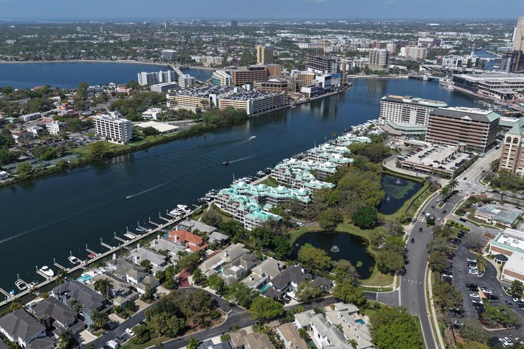 An aerial view of a waterfront residential complex with a marina and nearby city buildings — 0 SEDDON COVE WAY UNIT 19, TAMPA, FL