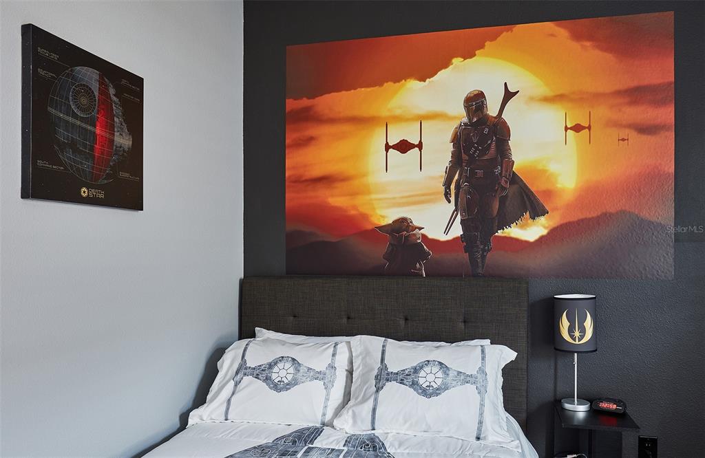 A bedroom features a Star Wars-themed wall mural, bedding, and a Death Star wall print — 351 PENDANT COURT, KISSIMMEE, FL