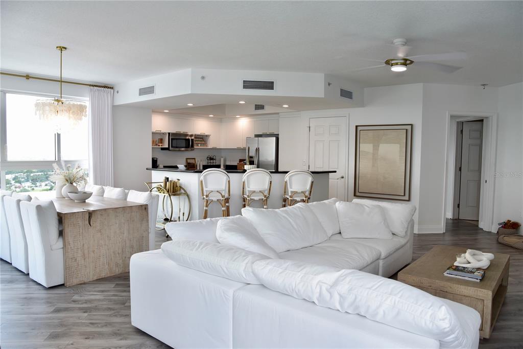 An open-concept living and dining area features a white kitchen with a breakfast bar — 241 RIVERSIDE DRIVE UNIT 2009, HOLLY HILL, FL