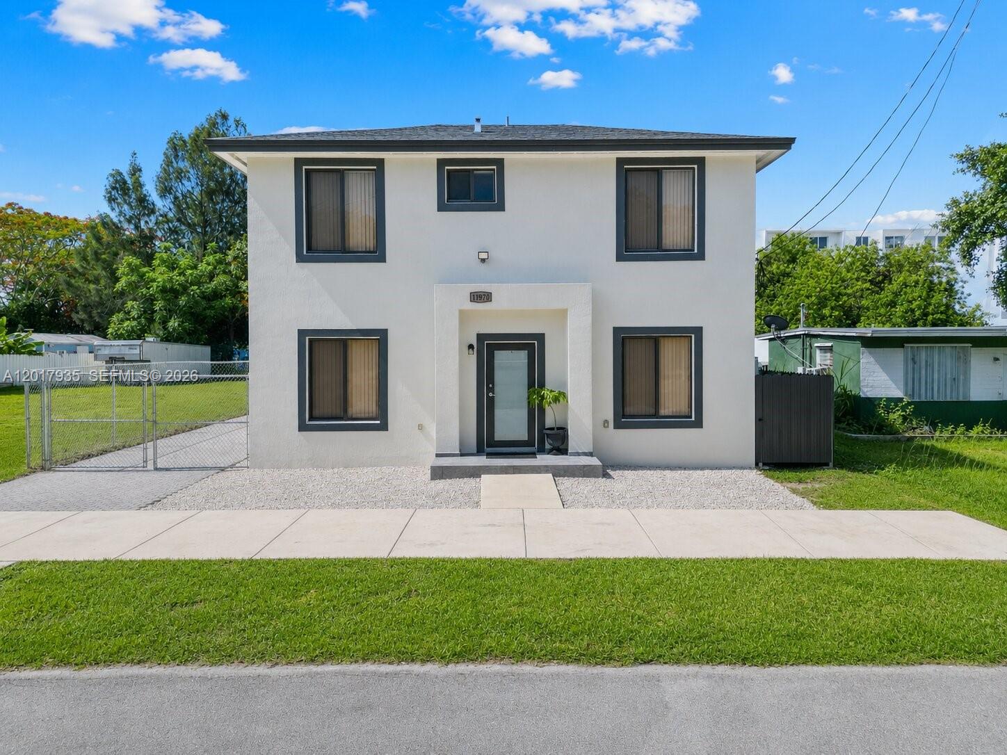 A two-story, white stucco house with a flat roof and dark-trimmed windows — 11970 SW 215th St # B, Miami FL 33177, MIAMI, FL