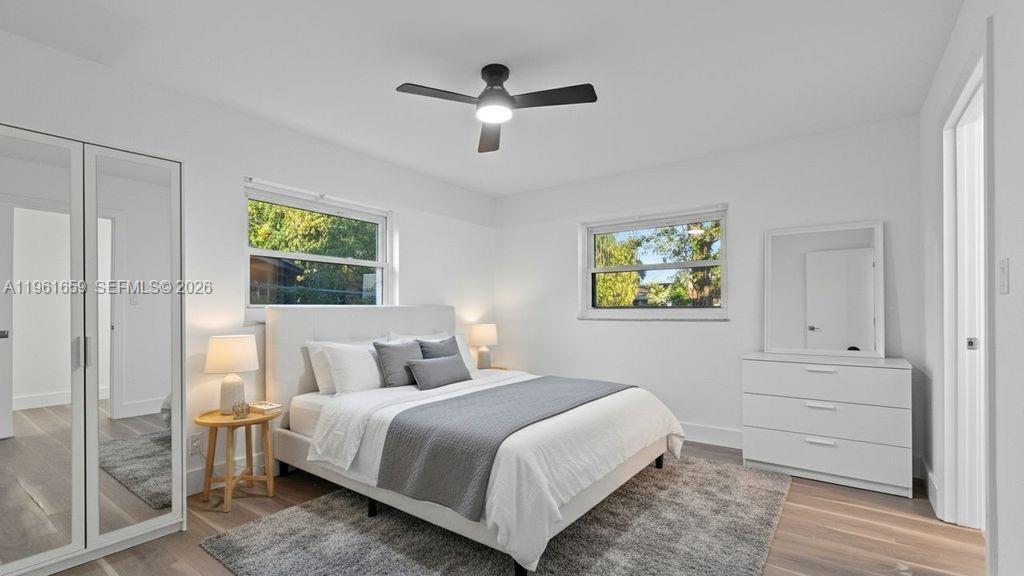 A bedroom with white walls, a bed, a dresser, a mirror, and a ceiling fan — 256 NW 78th Terrace, Margate FL 33063, MARGATE, FL