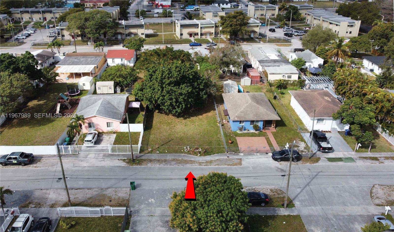 An aerial view shows a vacant residential lot situated between two single-family houses — 7610 NW 15th Ave, Miami FL 33147, MIAMI, FL