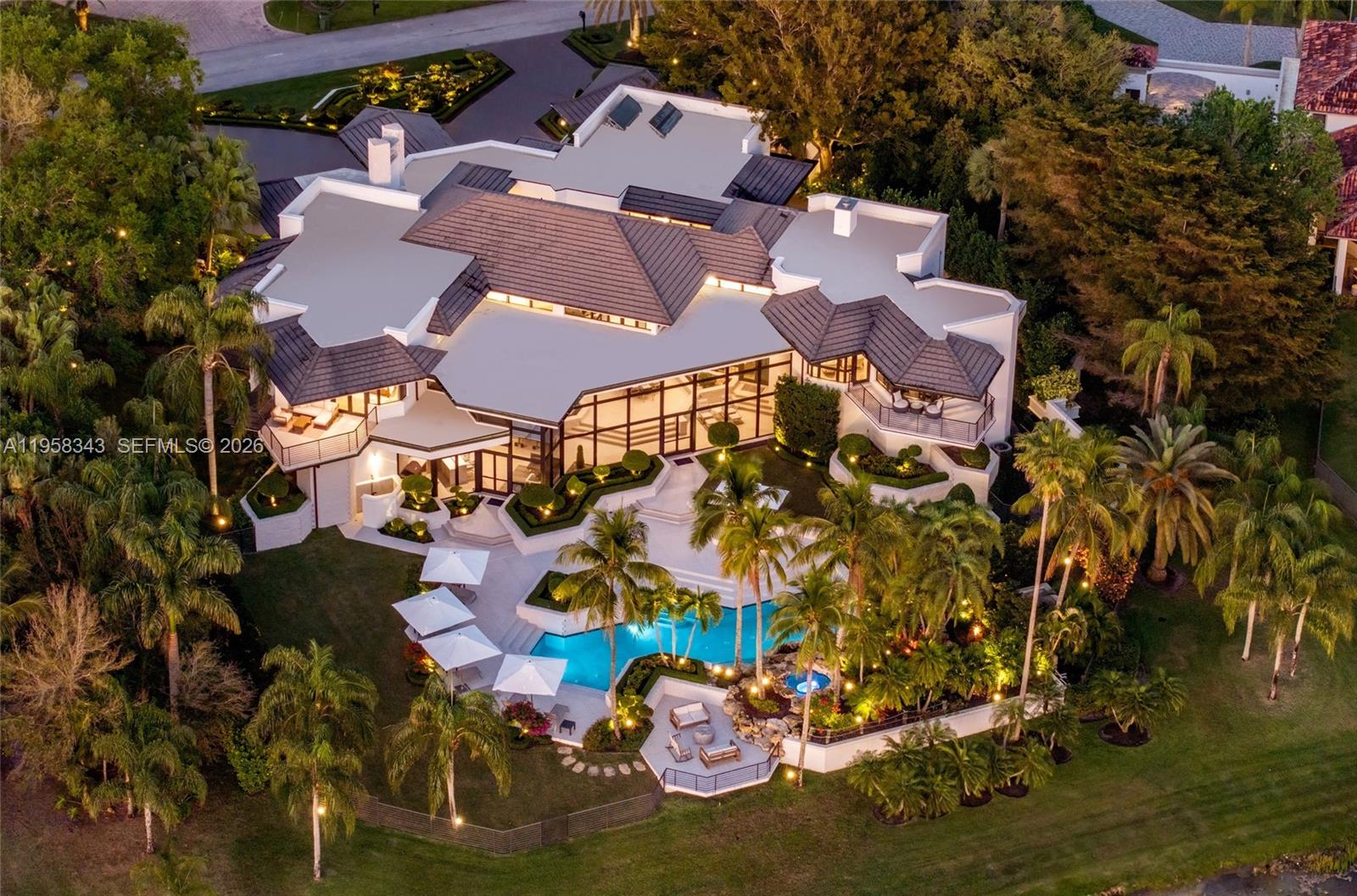 An aerial view of a large, multi-level house with a swimming pool and tropical landscaping — 2965 Surrey Ln, Weston FL 33331, WESTON, FL