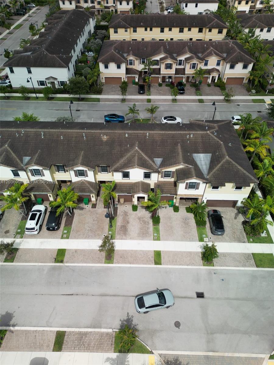 An aerial view shows a row of townhouses with paved driveways and parked cars — 4715 Caspian Way, Davie FL 33314, DAVIE, FL