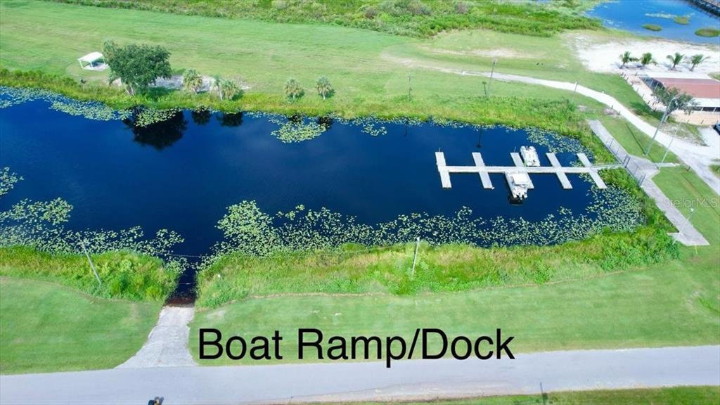 An aerial view shows a boat ramp and a dock on a small lake — 623 JAPONICA AVENUE, INDIAN LAKE ESTATES, FL
