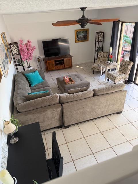 A high-angle view of a living room featuring a large sectional sofa and tile flooring — 2813 28th Court, Jupiter FL 33477, JUPITER, FL
