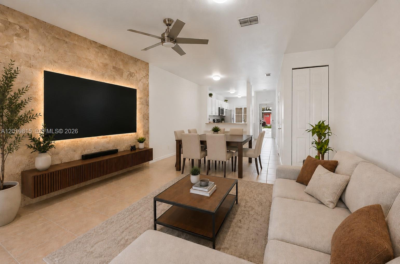 A living and dining area features a stone accent wall, floating console, and tile flooring — 1820 SW 89th Ter, Miramar FL 33025, MIRAMAR, FL