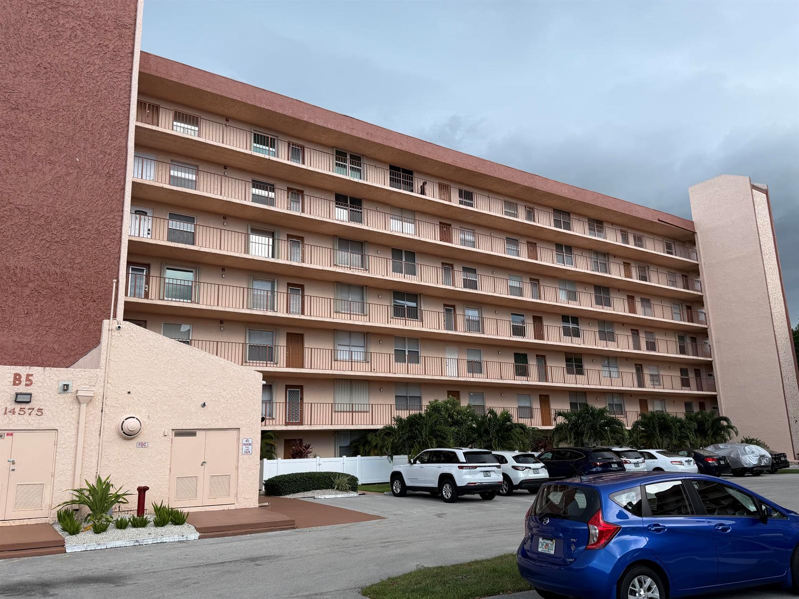 A multi-story apartment building with balconies and a parking lot in front — 14575 Bonaire Boulevard # 206, Delray Beach FL 33446, DELRAY BEACH, FL