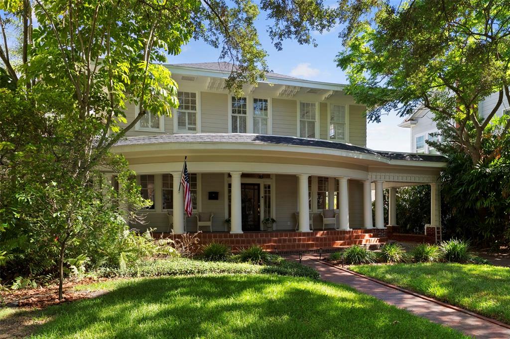 A two-story house with a curved front porch, white columns, and a brick walkway — 2630 W PROSPECT ROAD, TAMPA, FL