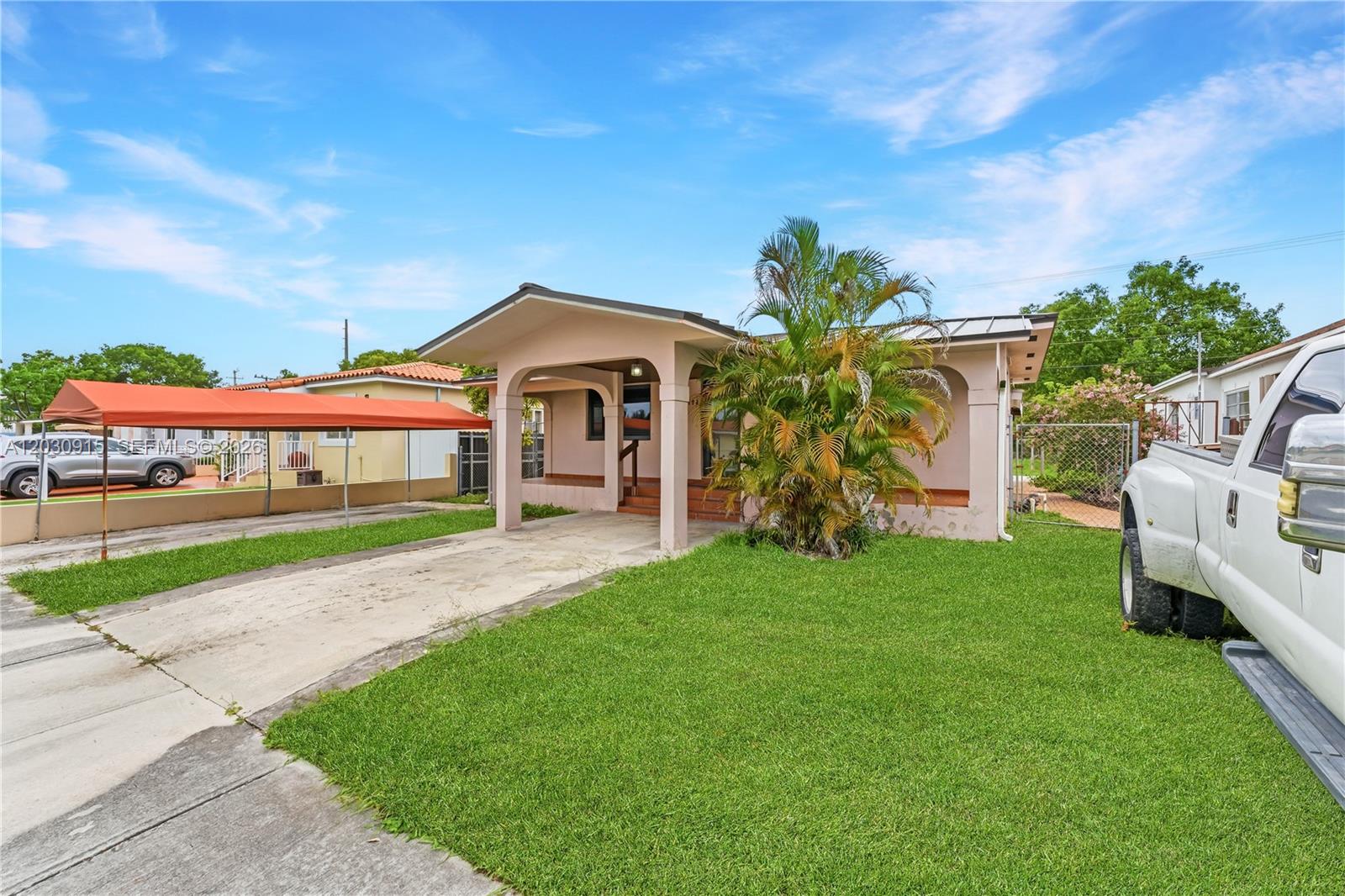 A single-story house with a covered porch, a concrete driveway, and a front lawn — 121 SW 71st Ave, Miami FL 33144, MIAMI, FL