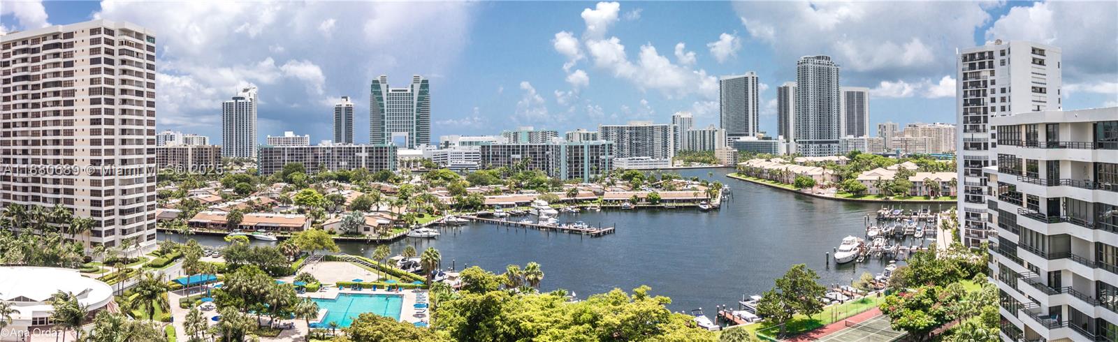 A high-angle panoramic view of a waterfront residential area with high-rise buildings and boats — 500 Three Islands Blvd # 822, Hallandale Beach FL 33009, HALLANDALE BEACH, FL