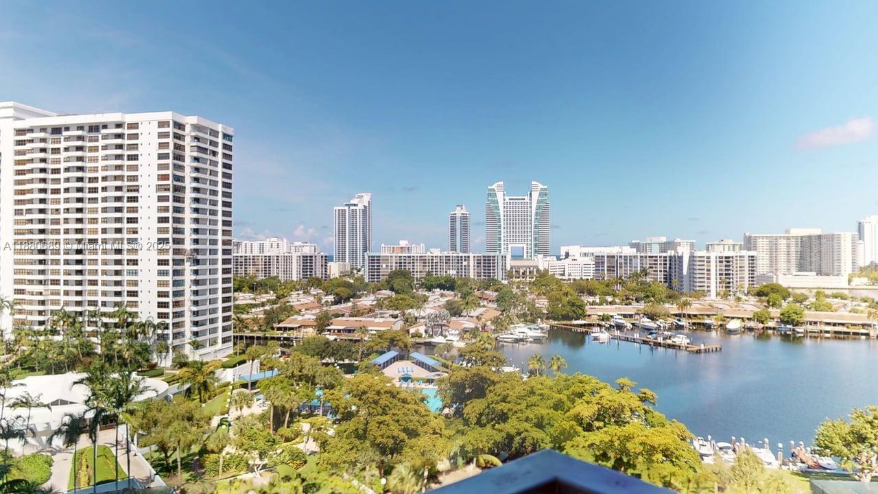 An elevated view of a waterfront residential area with high-rise buildings and a marina — 500 Three Islands Blvd # 822, Hallandale Beach FL 33009, HALLANDALE BEACH, FL