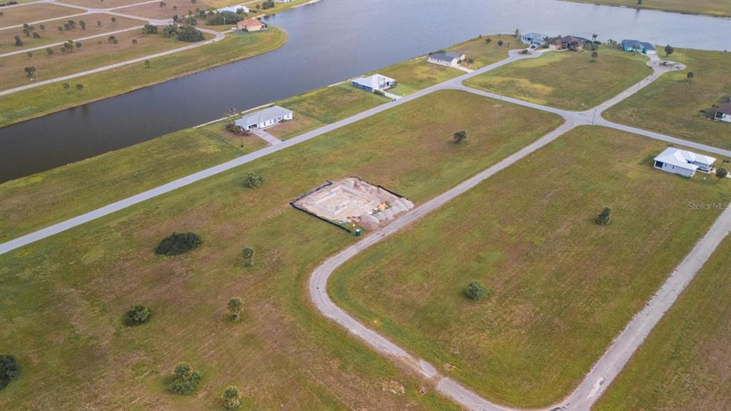 An aerial view shows a vacant residential lot with a concrete foundation under construction — 14163 PERMIT COURT, PLACIDA, FL