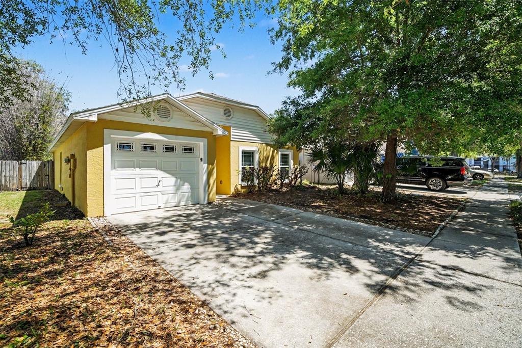 A yellow single-story house with a one-car garage and a concrete driveway — 2424 CAMDEN OAKS PLACE, VALRICO, FL