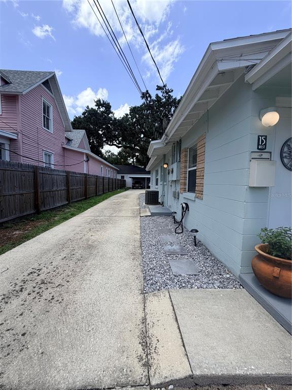 A concrete driveway runs between a light blue house and a pink house — 13 W PRINCETON STREET UNIT 15, ORLANDO, FL