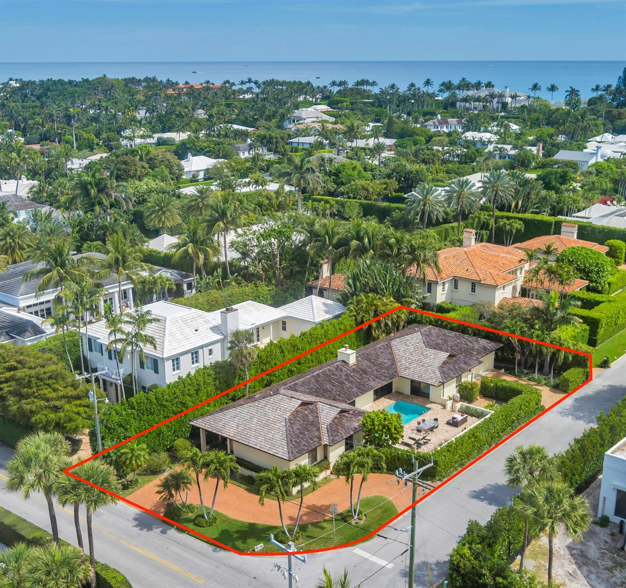 An aerial view shows a single-story house with a pool and a red driveway — 575 N Lake Way, Palm Beach FL 33480, PALM BEACH, FL