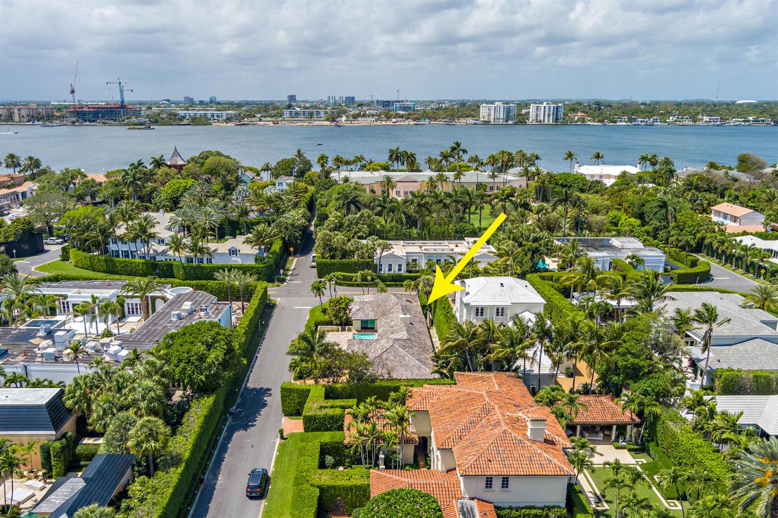 An aerial view shows a residential neighborhood with lush landscaping, swimming pools, and a waterfront — 575 N Lake Way, Palm Beach FL 33480, PALM BEACH, FL