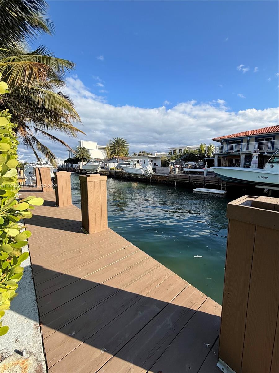 A single-story house features a brick driveway, a white garage door, and a tiled roof — 1240 NE 83rd St # 1240, Miami FL 33138, MIAMI, FL