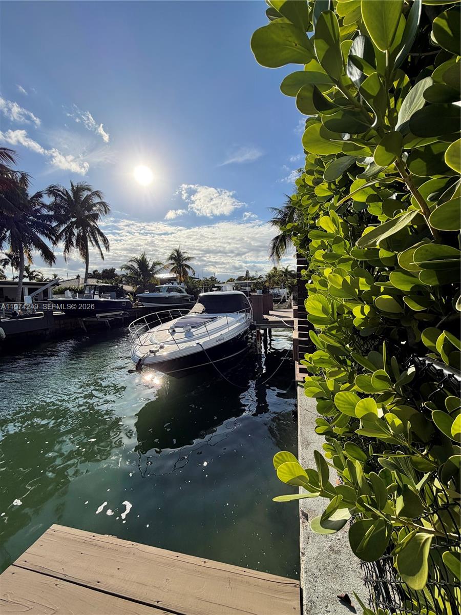 A backyard features a patio with dark tiles, a brick paver area, and a white house — 1240 NE 83rd St # 1240, Miami FL 33138, MIAMI, FL