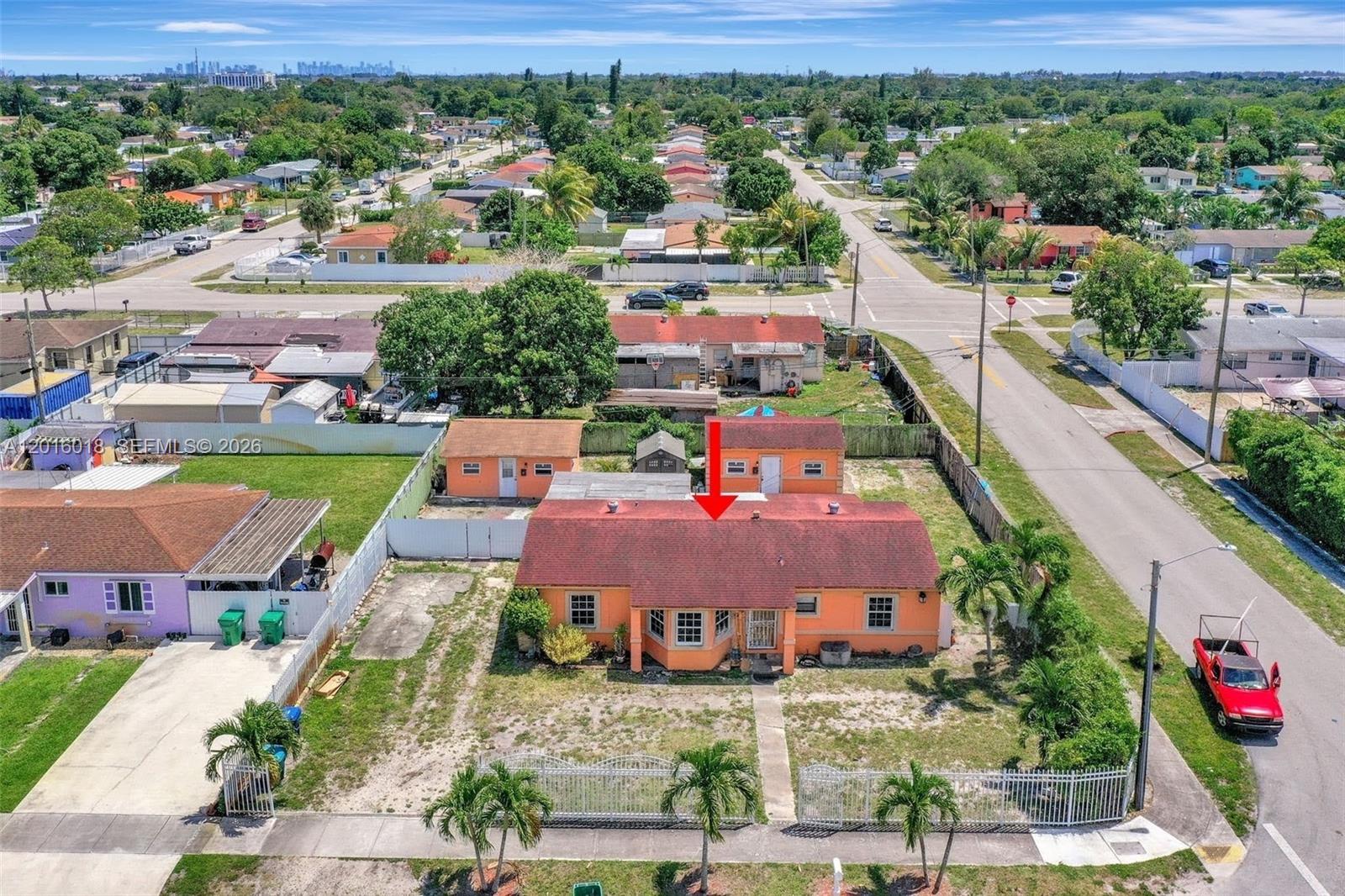 An aerial view shows an orange house with a red roof and a detached garage — 2890 NW 160th St, Miami Gardens FL 33054, MIAMI GARDENS, FL