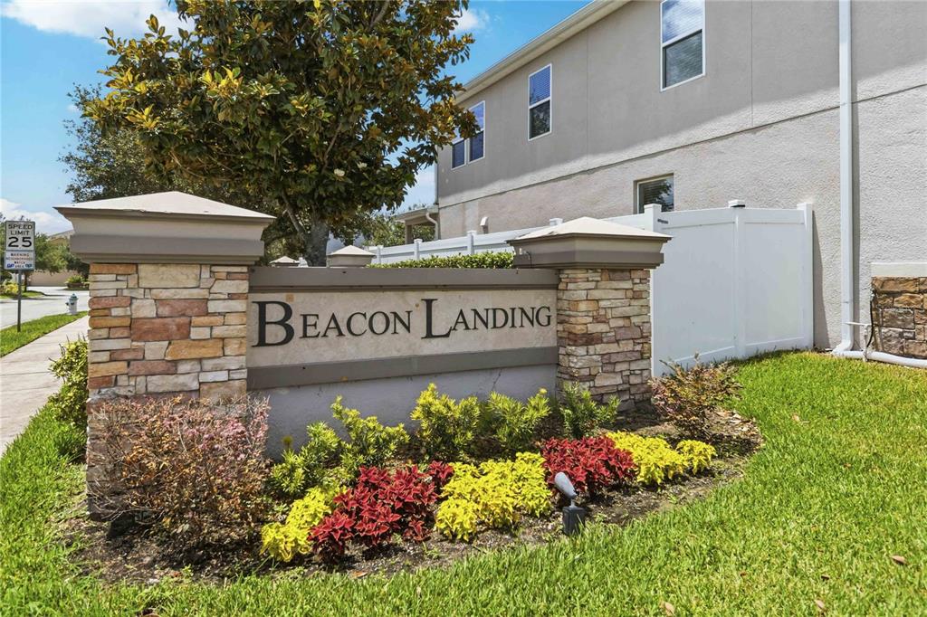 A stone and stucco monument sign for Beacon Landing stands in front of a house — 2015 BEACON LANDING CIRCLE, ORLANDO, FL