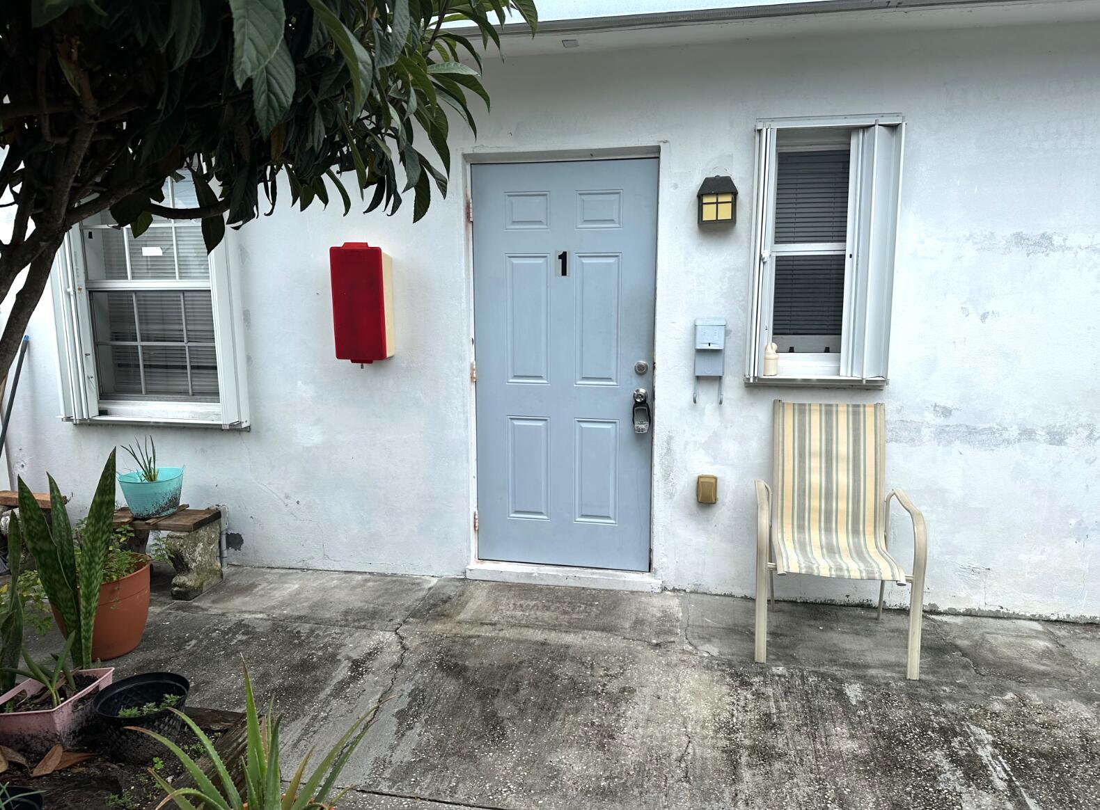 A light blue door marked with the number one sits on a white exterior wall — 31 SW 10th Street # 3, Dania Beach FL 33004, DANIA BEACH, FL