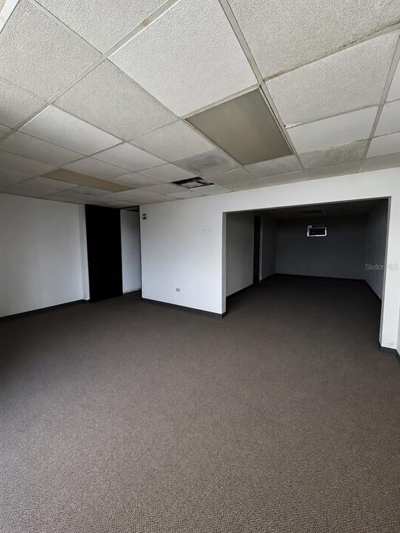 An empty office space features a drop ceiling, dark carpeting, and white walls — Avenida Font Martelo FLOR GERENA UNIT 110, HUMACAO, PR