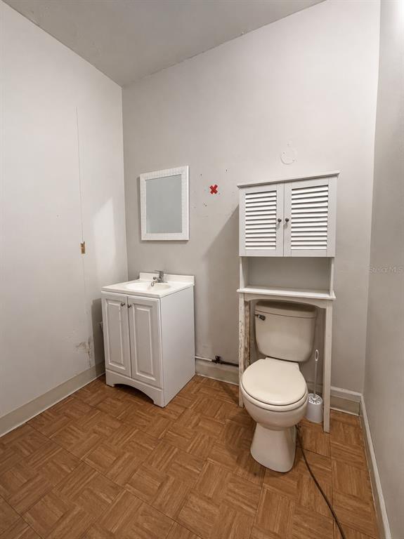 A bathroom features a white vanity, a toilet with an over-the-toilet storage unit, and flooring — Avenida Font Martelo FLOR GERENA UNIT 110, HUMACAO, PR