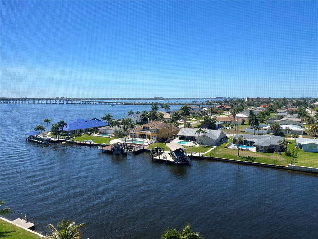 An aerial view shows waterfront houses with private docks and pools along a canal — 4260 SE 20TH PLACE UNIT 801, CAPE CORAL, FL