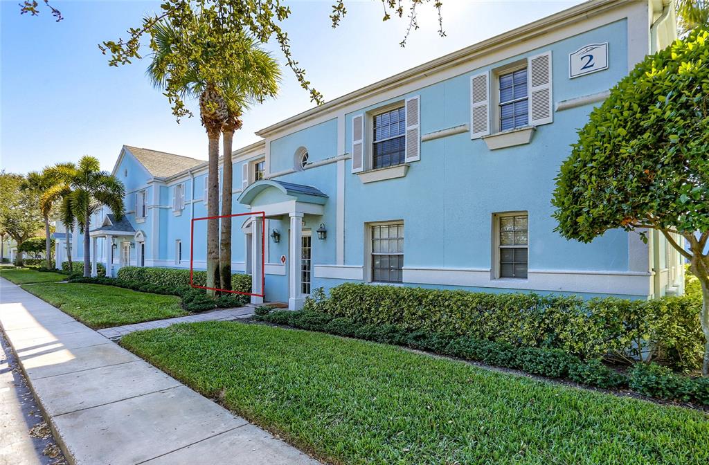 A two-story light blue apartment building features a palm tree near the front entrance — 4975 COBIA DRIVE SE UNIT A, ST PETERSBURG, FL