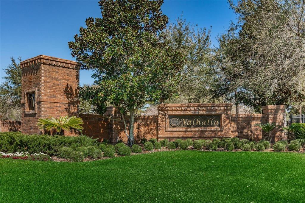 A two-story townhouse exterior with beige stucco, brown shutters, and a covered front entryway — 4517 KENNEWICK PLACE, RIVERVIEW, FL