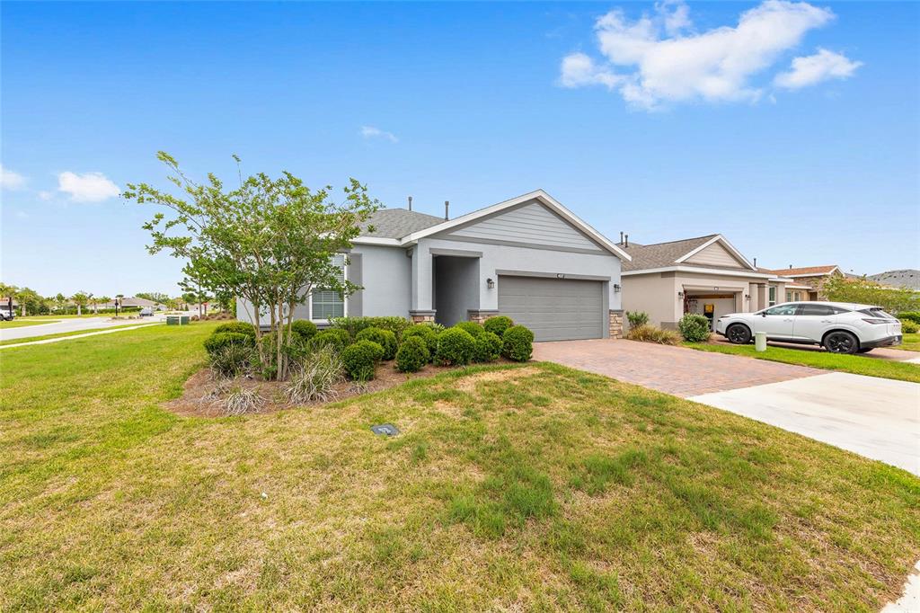 A single-story house with a gray exterior, a two-car garage, and a landscaped front yard — 4537 NW 53RD COURT, OCALA, FL