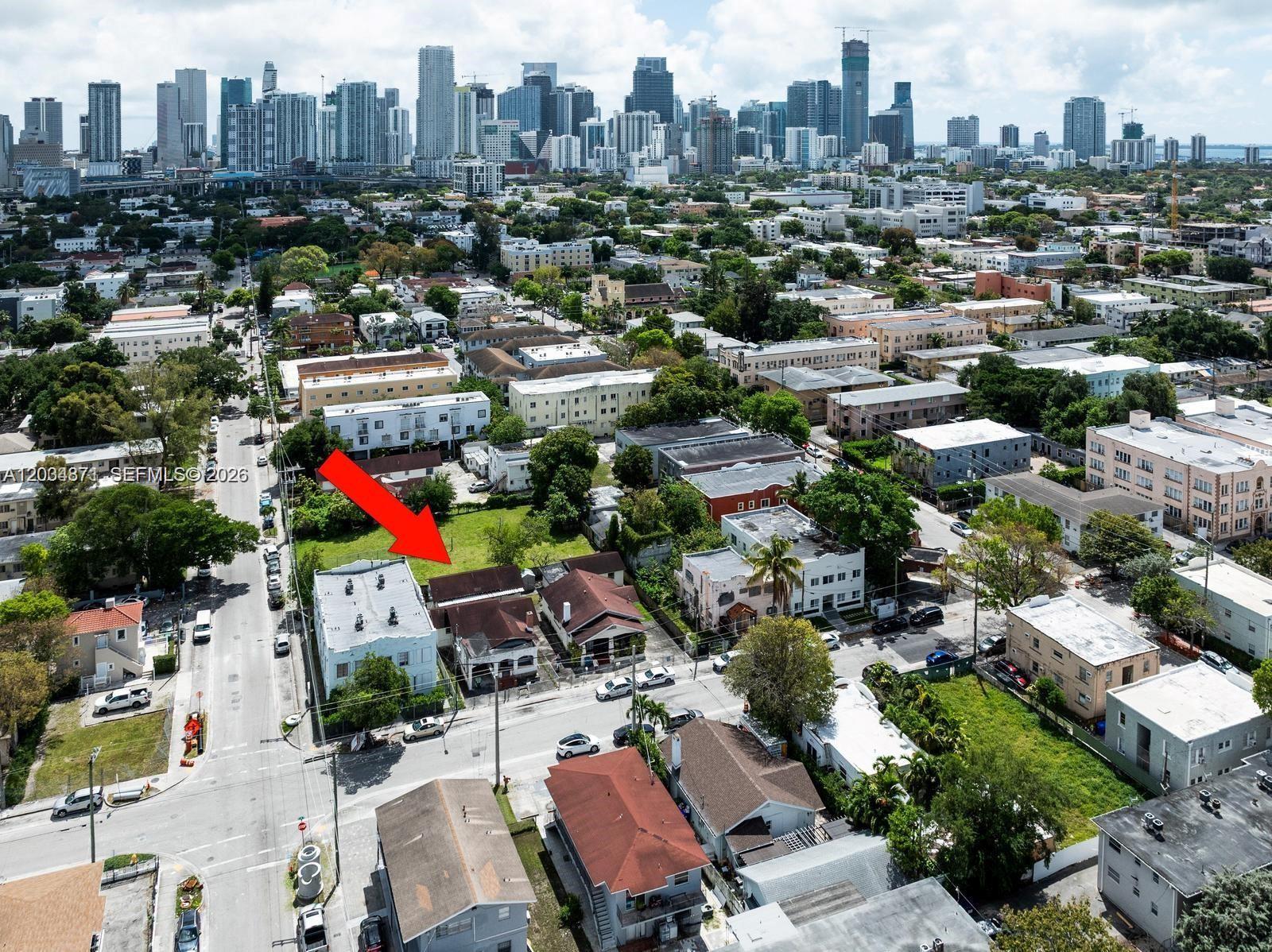 An aerial view shows a vacant lot and adjacent residential buildings in a city — 311 SW 10th Ave, Miami FL 33130, MIAMI, FL