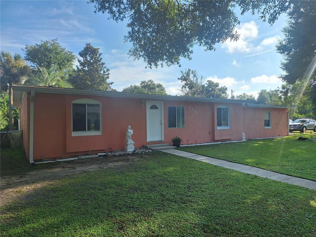 A single-story peach-colored house with a white front door and a concrete walkway — 3755 SE 139TH STREET, SUMMERFIELD, FL