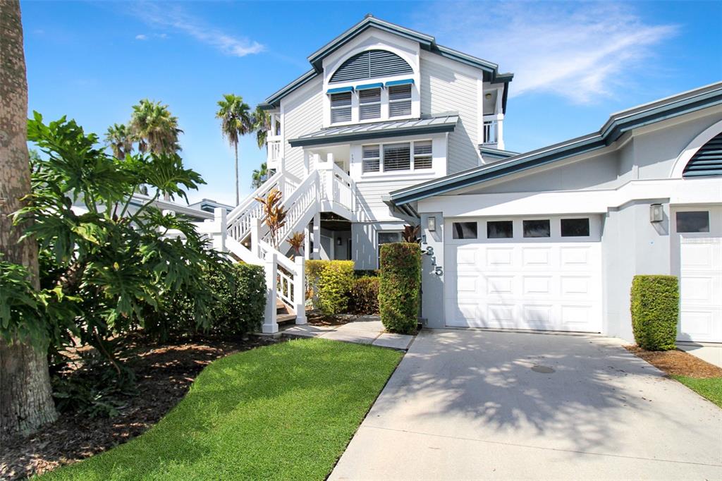 A multi-story house with a white exterior, a garage, and an outdoor staircase — 1315 SIESTA BAYSIDE DRIVE UNIT 1315B, SARASOTA, FL