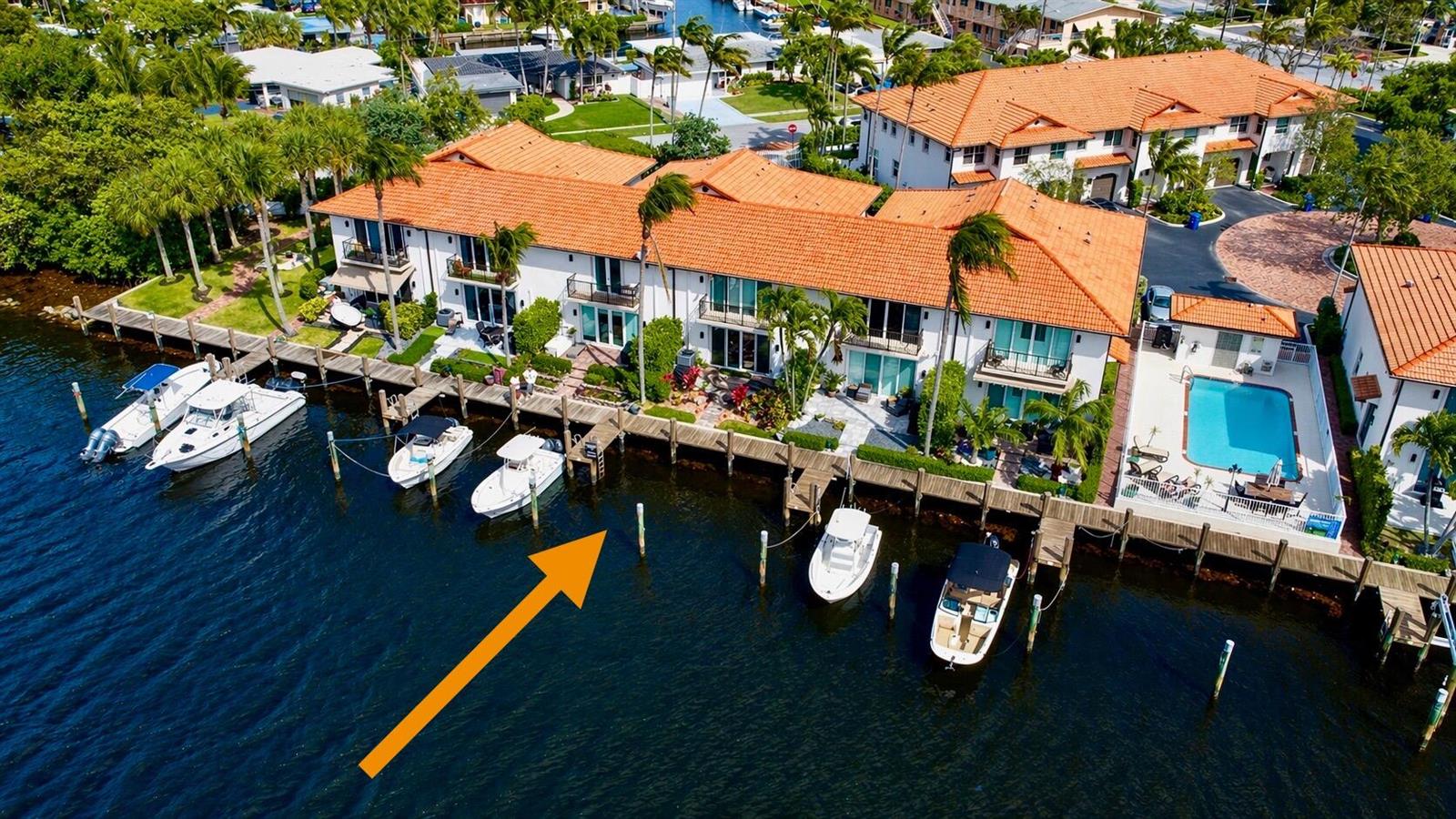 An open-concept living and dining area features leather furniture, a large red rug, and kitchen — 1365 SE 3rd Avenue, Pompano Beach FL 33060, POMPANO BEACH, FL
