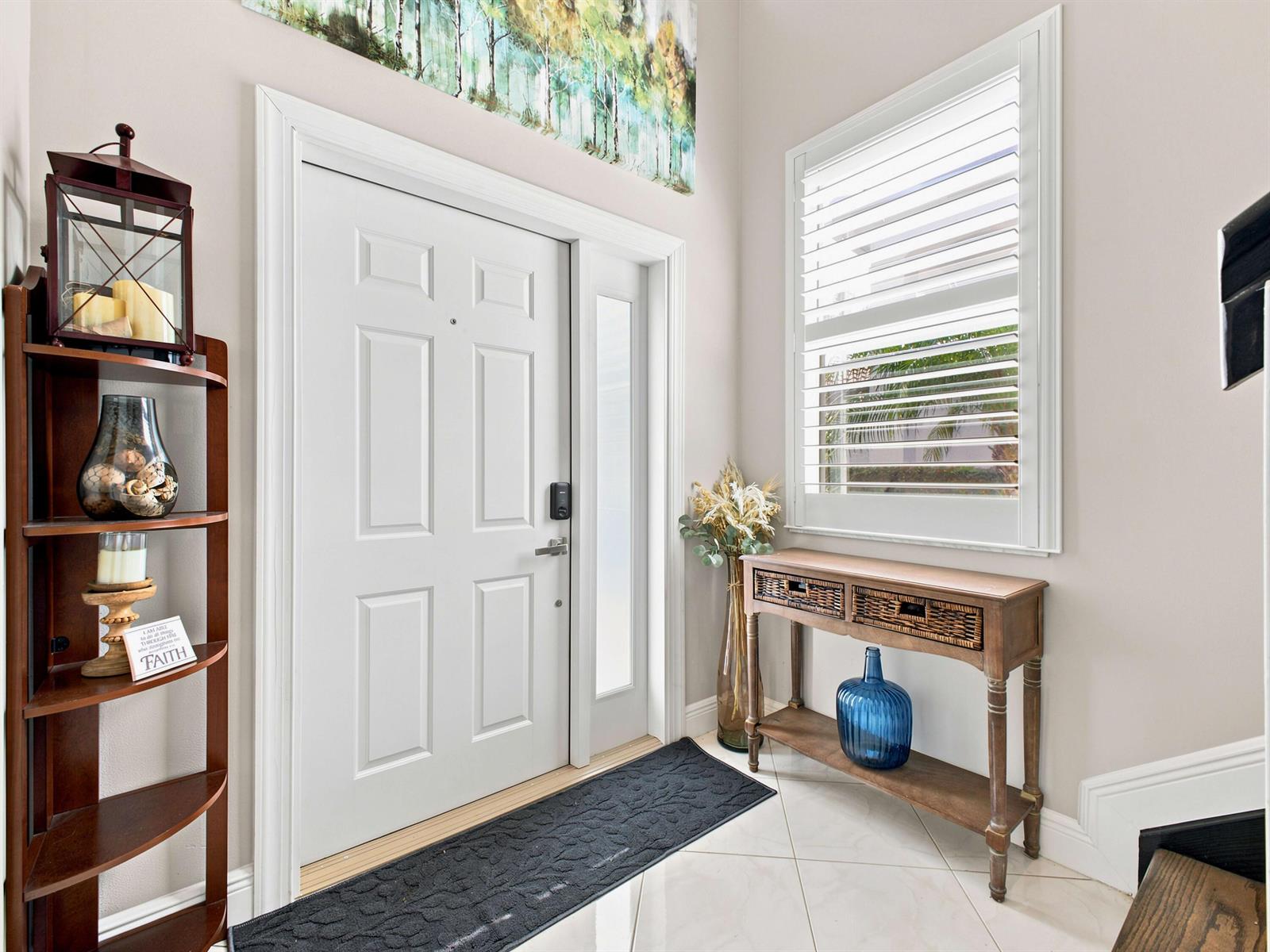 An entryway features a white front door, a console table, and a tall wooden shelf — 7960 Laina Lane Unit 3, Boynton Beach FL 33437, BOYNTON BEACH, FL