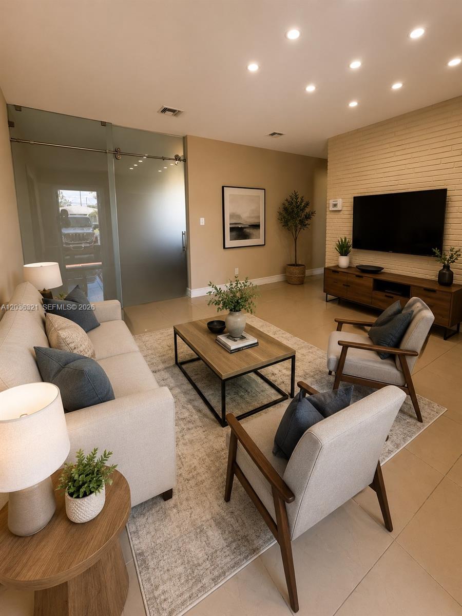 A modern living room features a beige sofa, two armchairs, a coffee table, and a television — 4011 SW 28th St # 0, West Park FL 33023, WEST PARK, FL