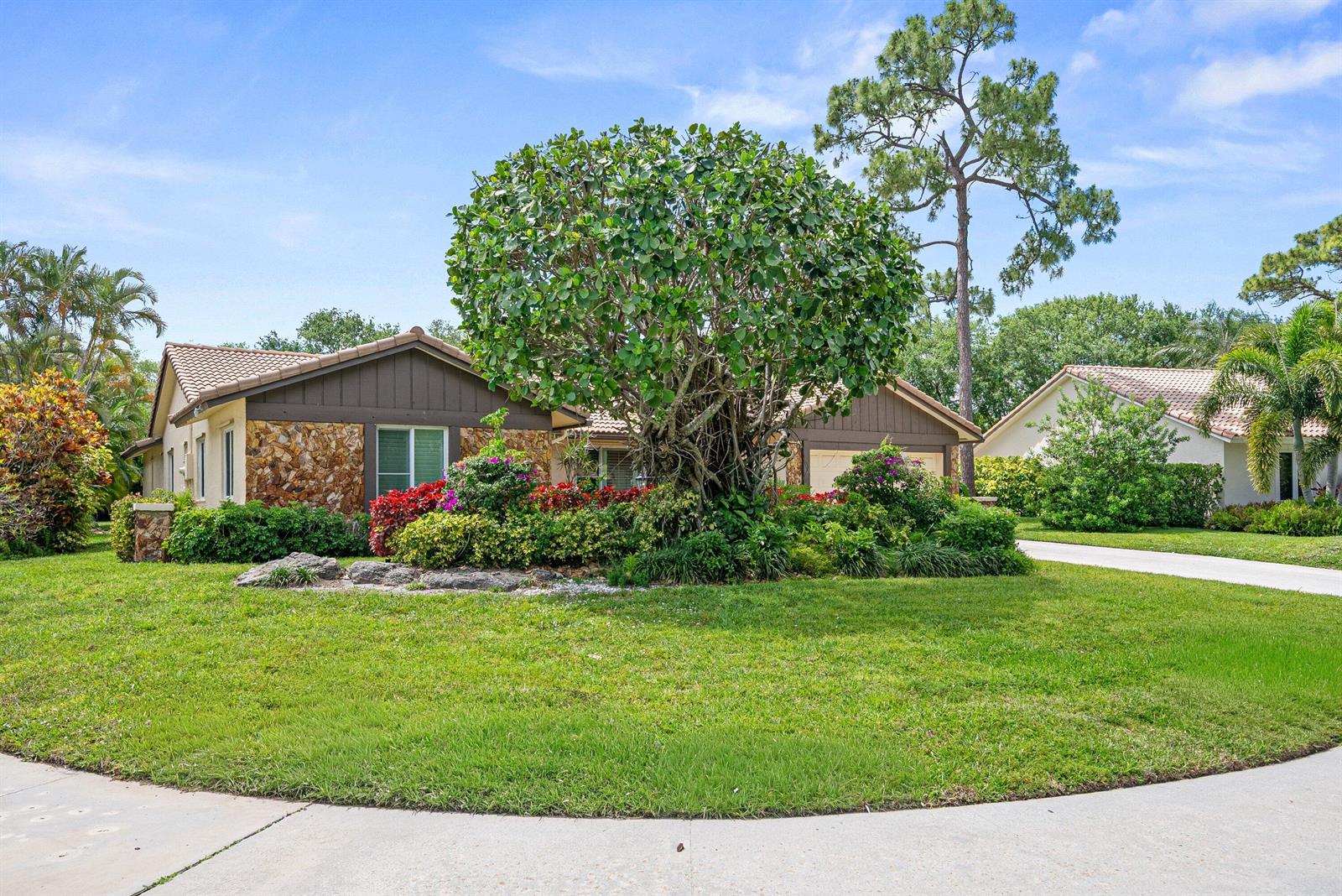 A single-story house with a stone facade and a large tree in the front yard — 2493 Timbercreek Circle NW, Boca Raton FL 33431, BOCA RATON, FL