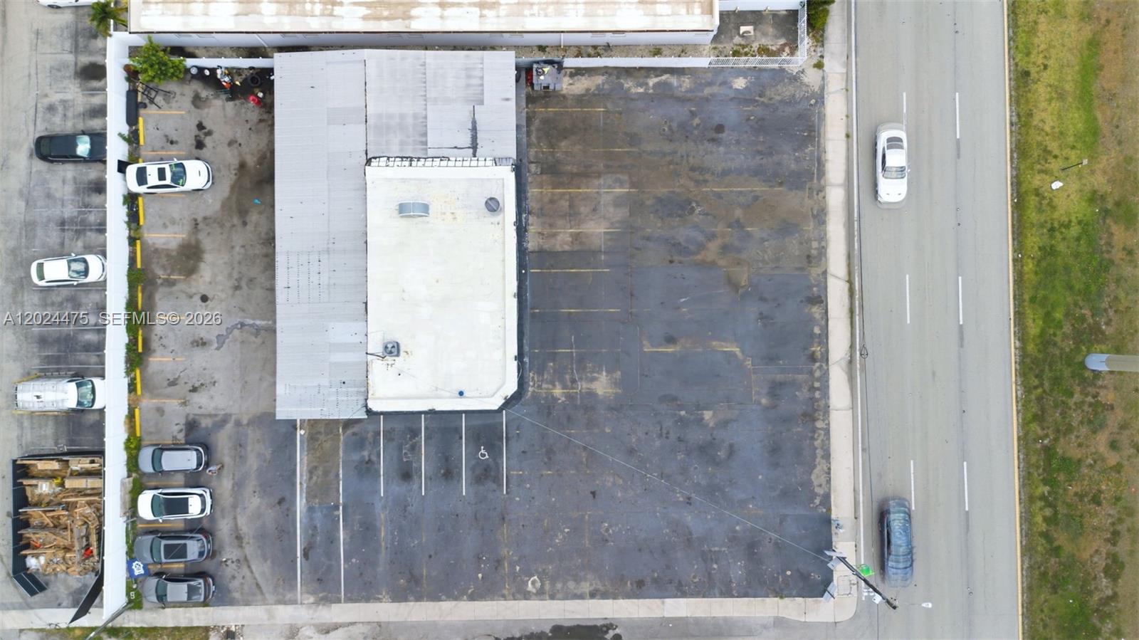 An aerial view shows a commercial building with a parking lot and adjacent road — 612 N Dixie Hwy, Hollywood FL 33020, HOLLYWOOD, FL