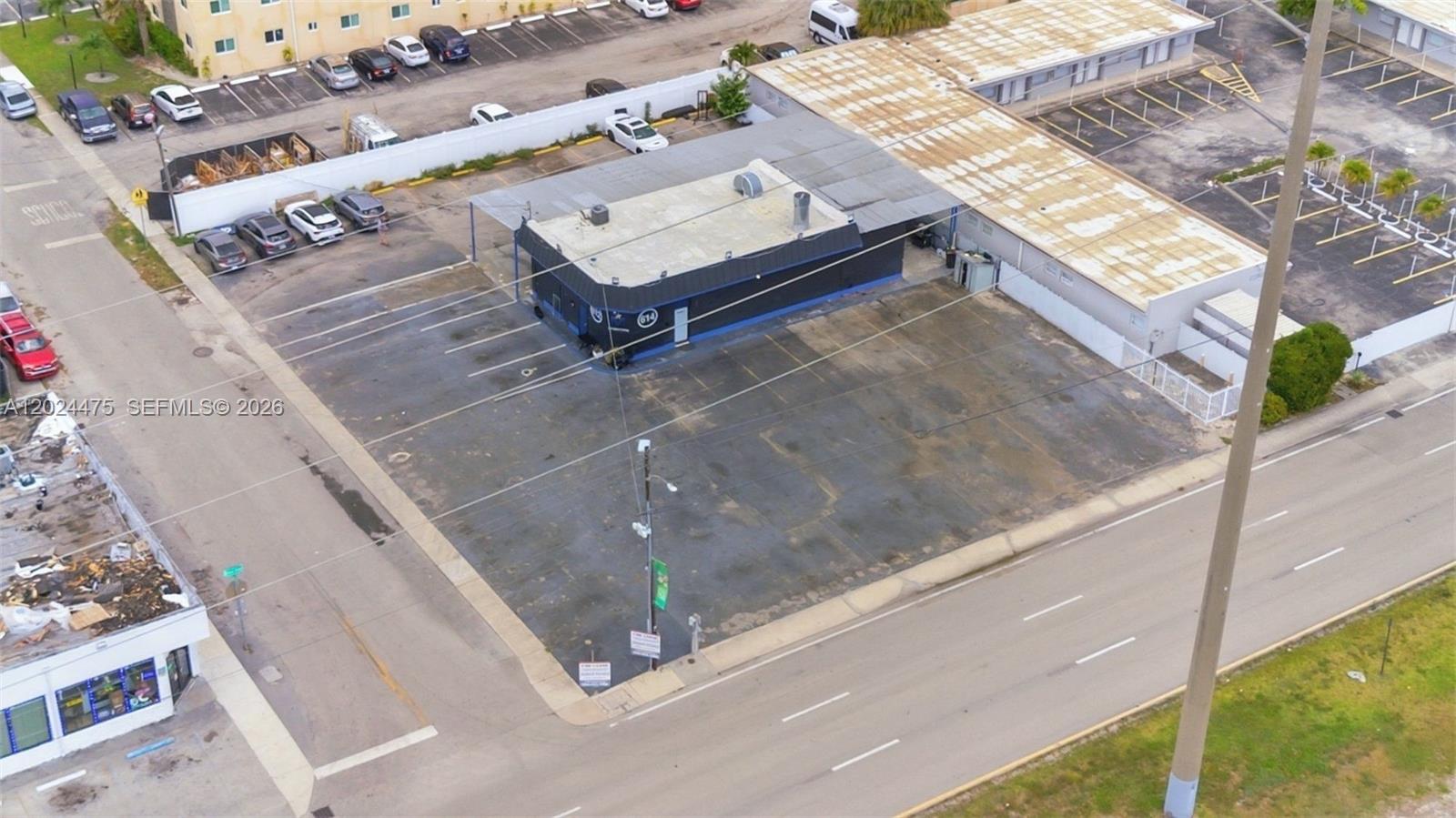 An aerial view shows a commercial building with a large parking lot and surrounding streets — 612 N Dixie Hwy, Hollywood FL 33020, HOLLYWOOD, FL