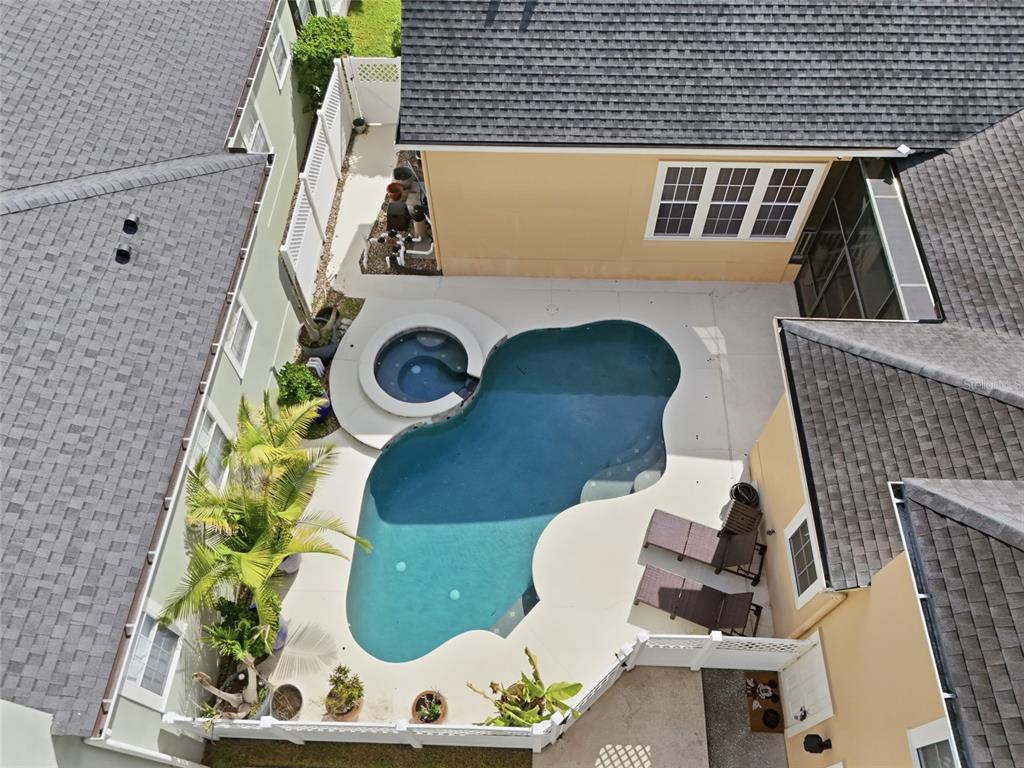 This aerial view shows a residential property with a swimming pool and a red outline — 1018 WILD ELM STREET, CELEBRATION, FL