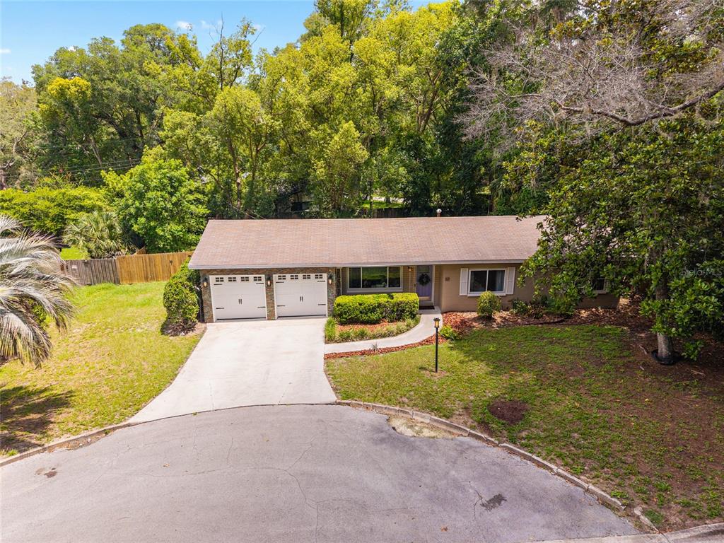 An elevated view of a single-story house with a two-car garage and a paved driveway — 3224 NW 31ST AVENUE, GAINESVILLE, FL