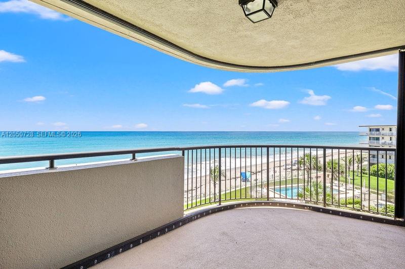 A curved balcony overlooks the ocean with a metal railing and a concrete floor — 4600 Highway A1a # 507, Vero Beach FL 32963, VERO BEACH, FL