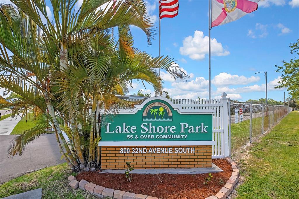A green sign for Lake Shore Park stands in front of a palm tree — 800 32ND AVENUE S UNIT 606, ST PETERSBURG, FL
