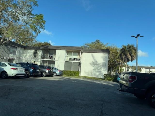 A two-story apartment building with a parking lot in front under a clear blue sky — 10353 N Kendall Dr # 6, Miami FL 33176, MIAMI, FL