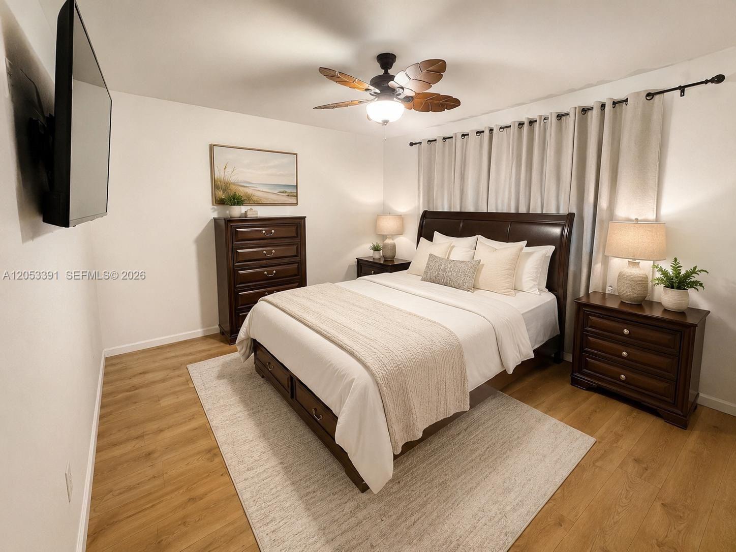 A bedroom features a dark wood bed frame, matching furniture, and a ceiling fan — 9821 W Elm Ln # 9821, Miramar FL 33025, MIRAMAR, FL