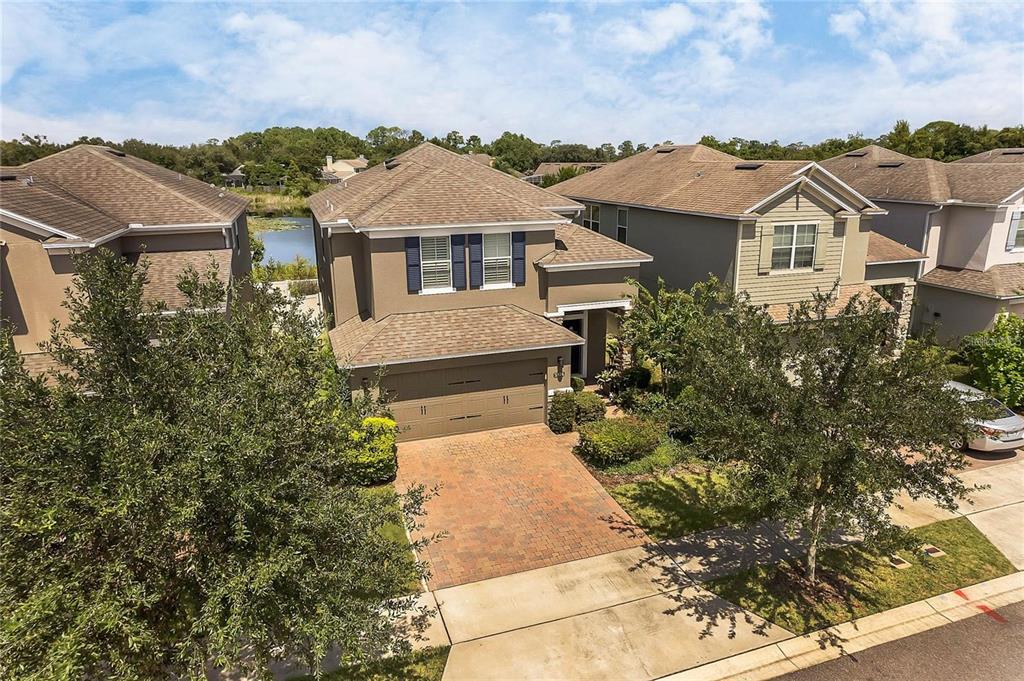 An aerial view of a two-story suburban house with a brick driveway and attached garage — 5924 PAXTON COURT, APOPKA, FL