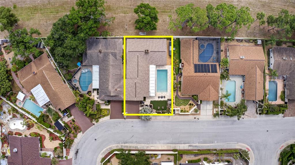 An aerial view shows a residential house with a swimming pool and a paved driveway — 13522 AVISTA DRIVE, TAMPA, FL