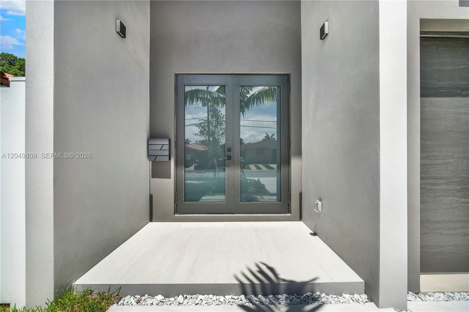 A modern entryway features double glass doors, a light-colored tiled porch, and gray walls — 2889 SW 35 Ave # 2887, Miami FL 33133, MIAMI, FL